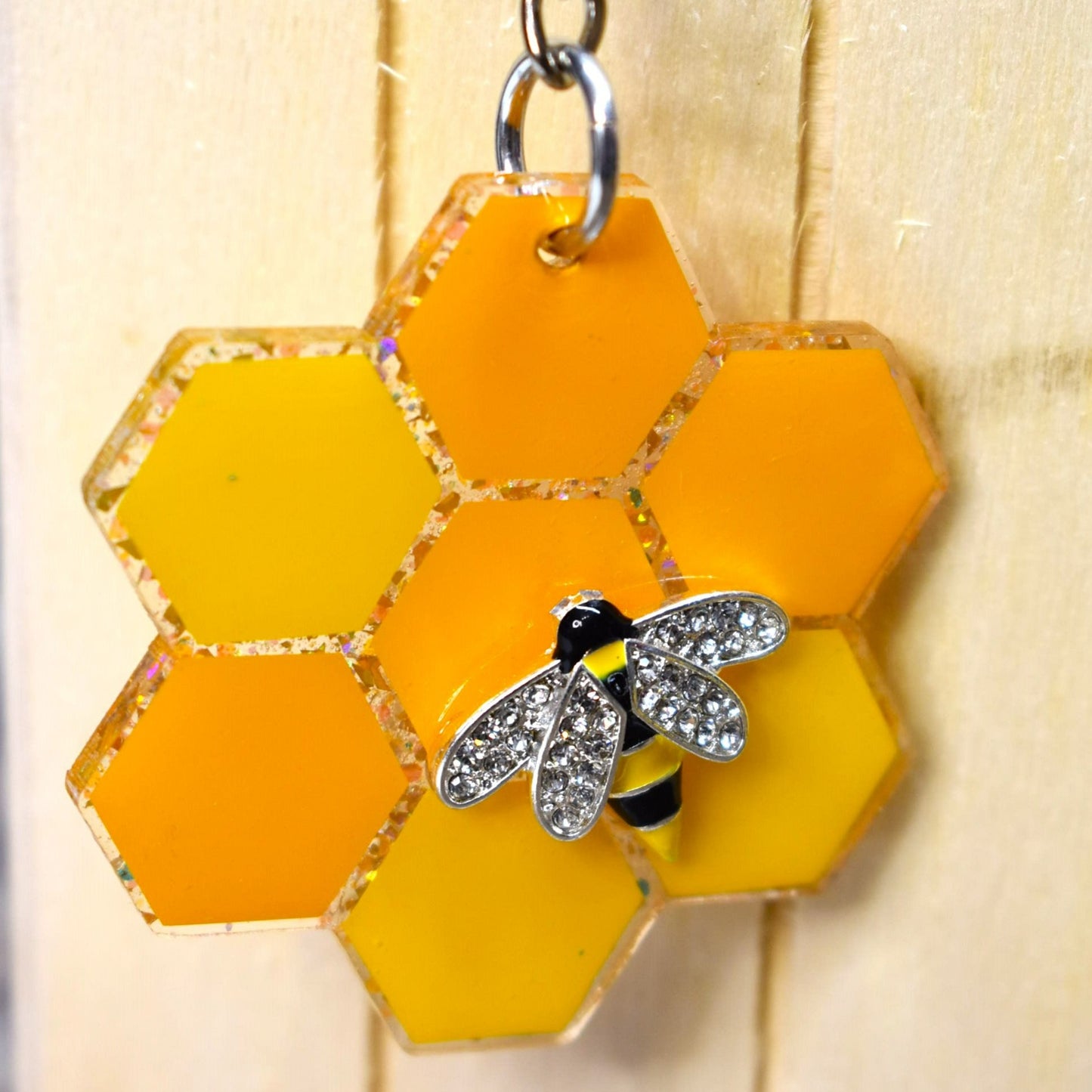 These Keychains are as busy as bees. With a Honey Comb pattern, glitter backs, and a sturdy acrylic resin material, you'll be buzzing with joy. Choose from 2 bee styles - a 2 wing or a 4 wing option.