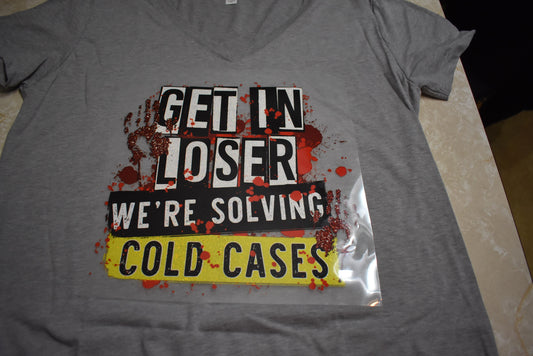  Up for some detective work? Get your crime T-shirt with a Screen Print Transfer with Get In Loser We're Solving Cold Cases. All shirts are Unisex adult sized. 