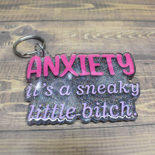 This acrylic keychain is designed to remind us of the sneaky nature of Anxiety - a sentiment that we must always be vigilant of.
