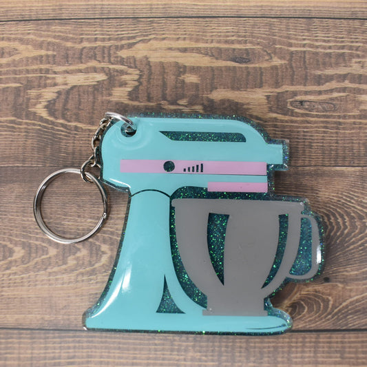 Acrylic keychain with a teal colored mixing bowl. A must for your favorite baker!