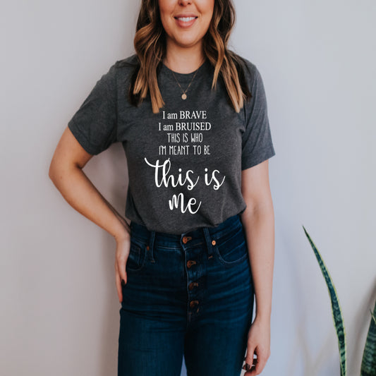 This T-Shirt features a Screen Print Transfer of the phrase "I Am Brave I Am Bruised This Is Who I'm Meant To Be... This Is Me" in crisp white lettering. Crafted from 5.3 oz. 100% pre-shrunk cotton, it ensures comfort and durability.