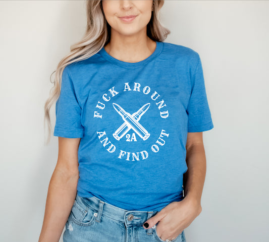 This T-shirt is decorated with a Screen Print Transfer in white lettering, and is crafted from 5.3 oz. 100% preshrunk cotton. The phrase "Fuck Around And Find Out" is featured prominently.