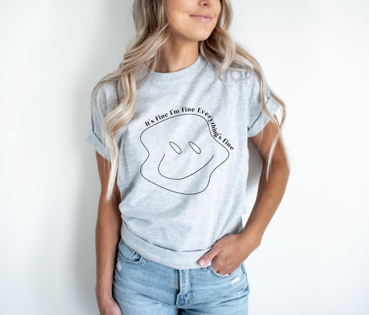 This Unisex adult-sized T-shirt features a Screen Print Transfer of a Warped Smiley face with white lettering. Crafted from 5.3oz 100% preshrunk cotton, Its Fine I'm Fine Everything's Fine is sure to be a favorite.